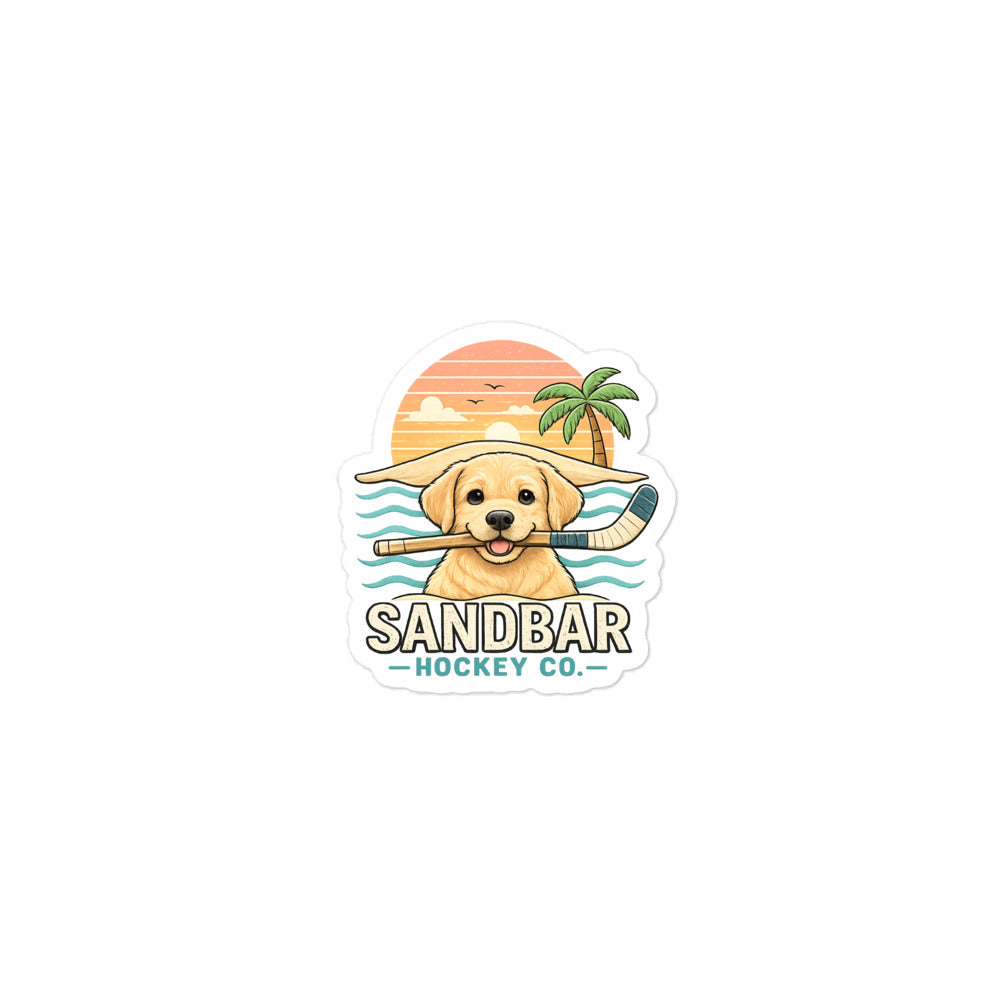 Medium Sandbar Hockey puppy sticker featuring a golden lab holding a hockey stick with a beach sunset, palm tree, ocean waves, and Sandbar Hockey Co. lettering.