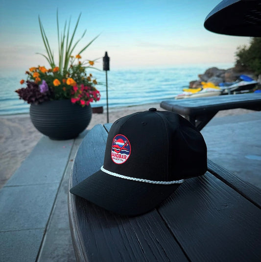 Sandbar Hockey USA embroidered snapback hat in black lifestyle photo by the water