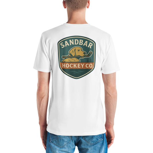 White hockey t-shirt shown from the back with a large Sandbar Hockey Co. dog shield graphic centered on the upper back, featuring a golden dog holding a hockey stick in its mouth.