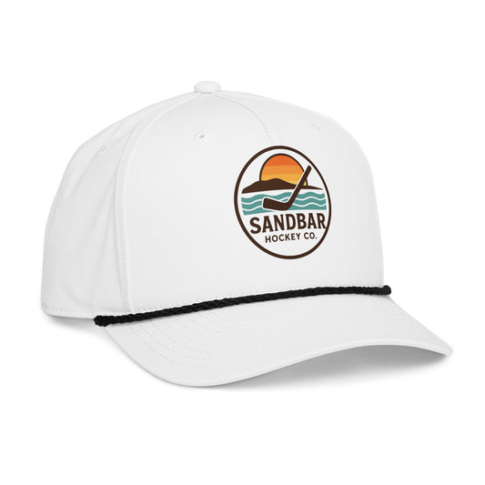 White hockey rope hat left front angle view with Sandbar Hockey Co. sunset puck logo, black rope detail, and curved brim.