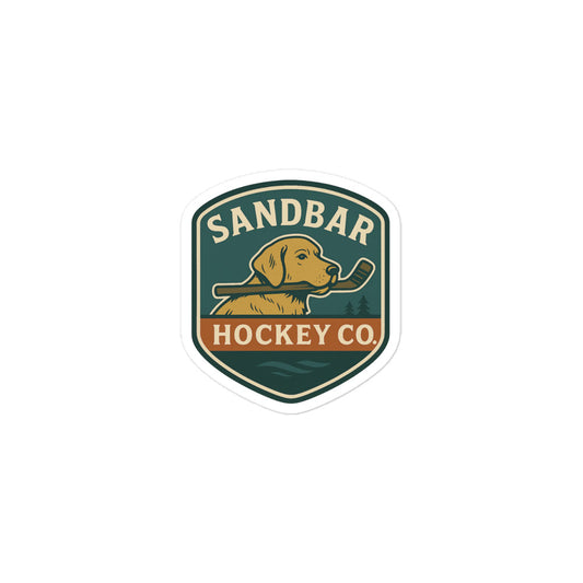 Small Hockey sticker featuring a dog holding a hockey stick in its mouth with “Sandbar Hockey Co.” text