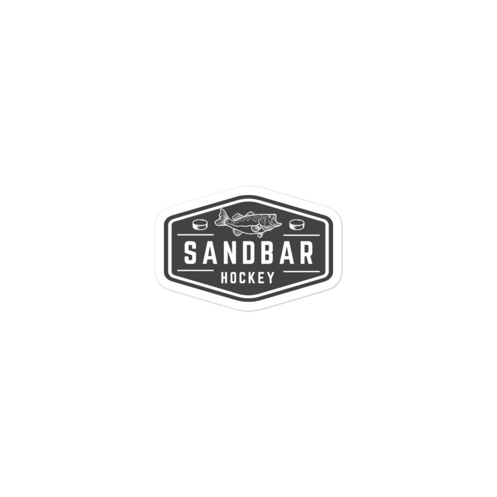 Small Sandbar Hockey sticker with a black-and-white badge logo featuring a fish above the words Sandbar Hockey and hockey pucks on each side.