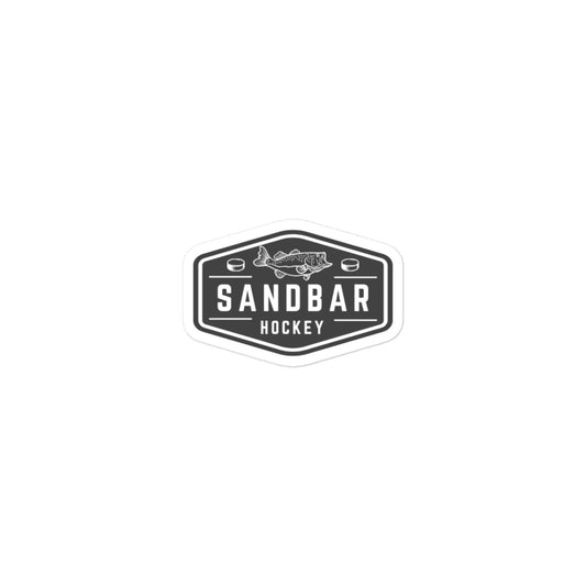 Small Sandbar Hockey sticker with a black-and-white badge logo featuring a fish above the words Sandbar Hockey and hockey pucks on each side.