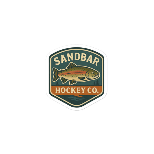 Small Sandbar Hockey Co. sticker with a badge-style design featuring a fish, outdoor background, and the words Sandbar Hockey Co.