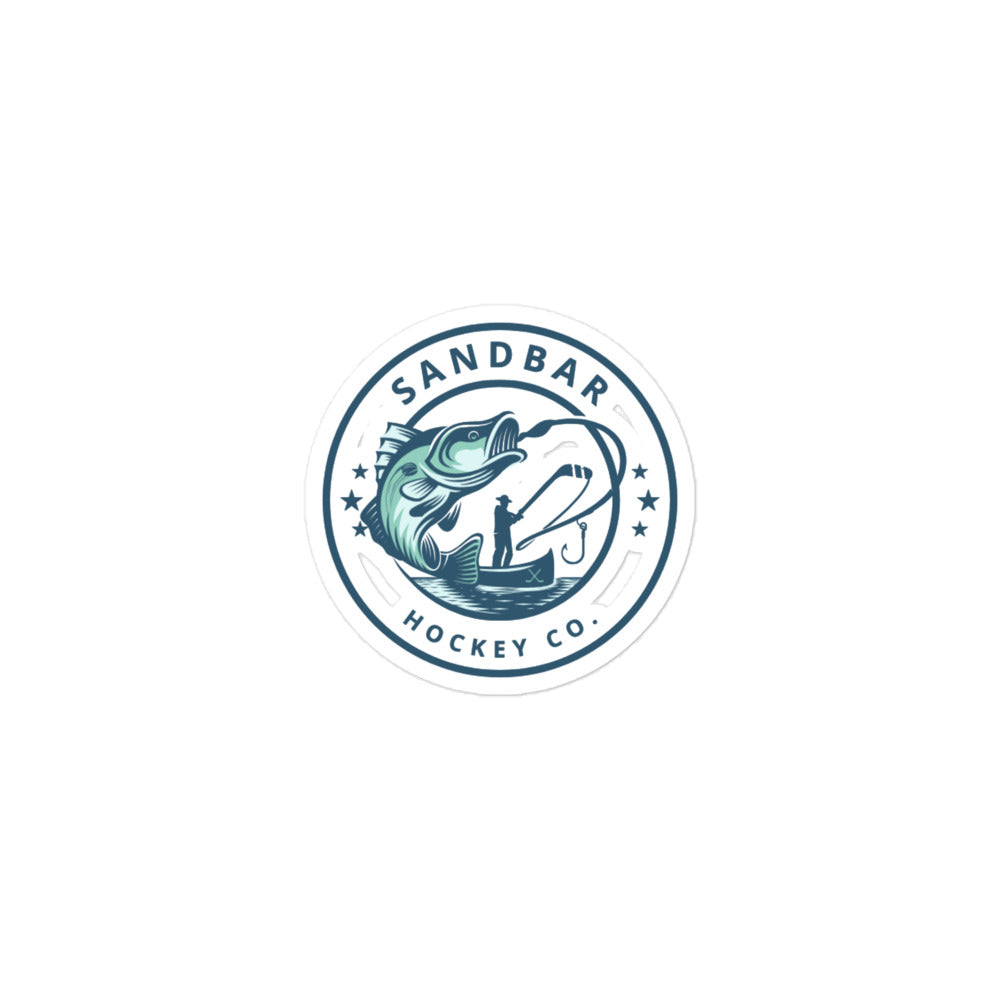 Small Sandbar Hockey Co. fishing sticker with a circular logo featuring a large fish, fisherman in a boat, fishing line, and stars.