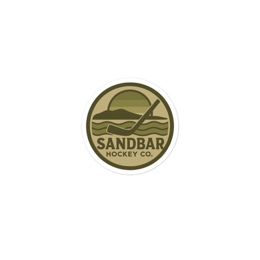 Small Sandbar Hockey Co. camo circular logo sticker featuring a coastal hockey scene with a sunset, shoreline, waves, and hockey stick.