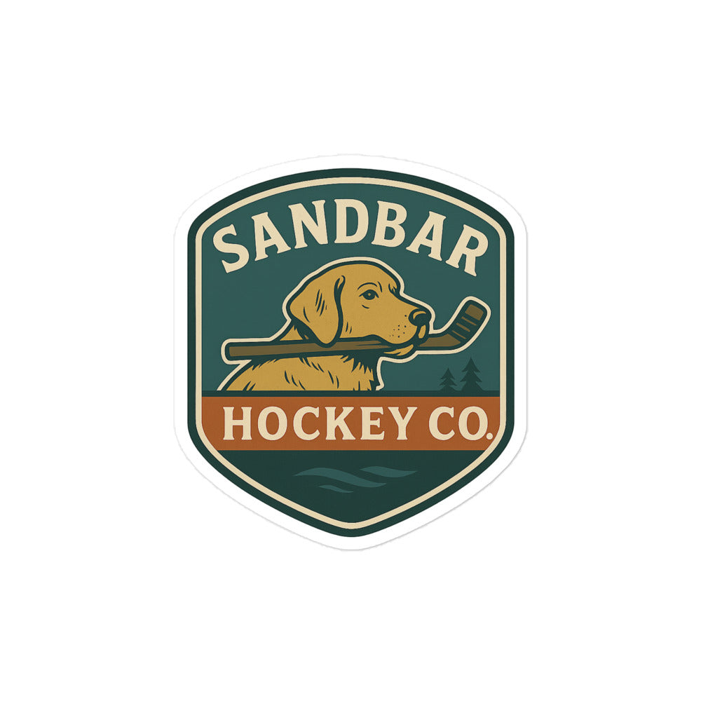 Medium Hockey sticker featuring a dog holding a hockey stick in its mouth with “Sandbar Hockey Co.” text