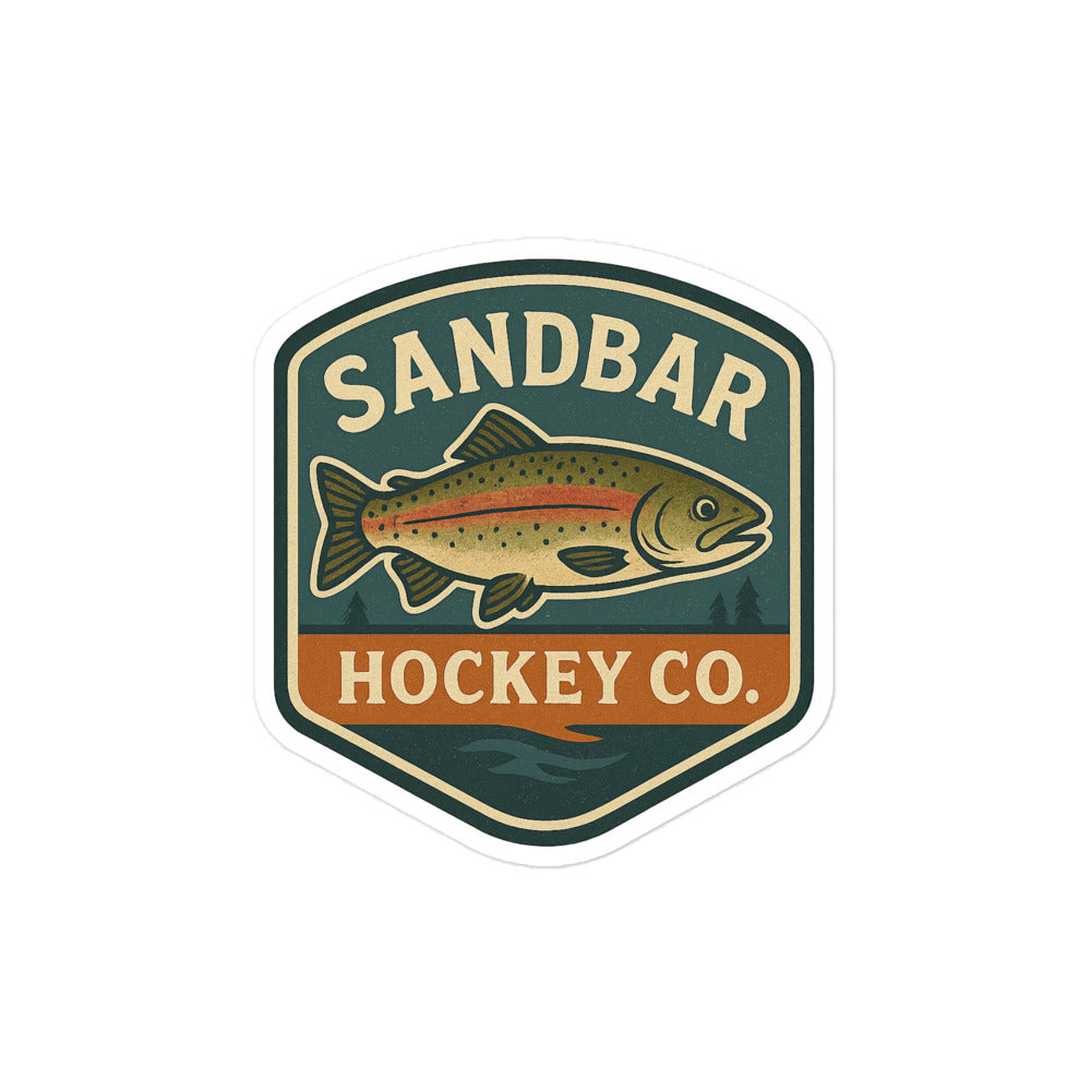 Medium Sandbar Hockey Co. sticker with a badge-style design featuring a fish, outdoor background, and the words Sandbar Hockey Co.