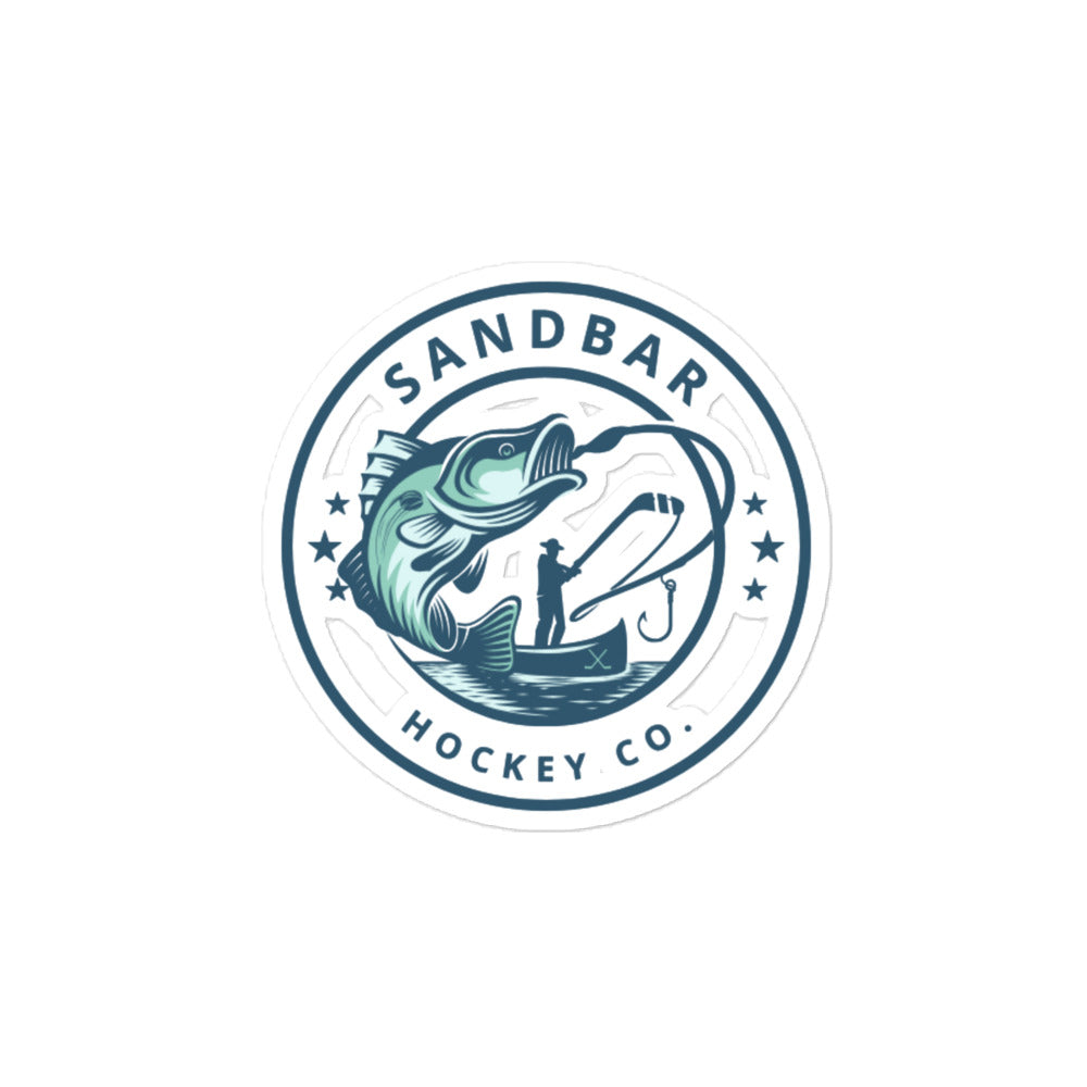 Medium Sandbar Hockey Co. fishing sticker with a circular logo featuring a large fish, fisherman in a boat, fishing line, and stars.