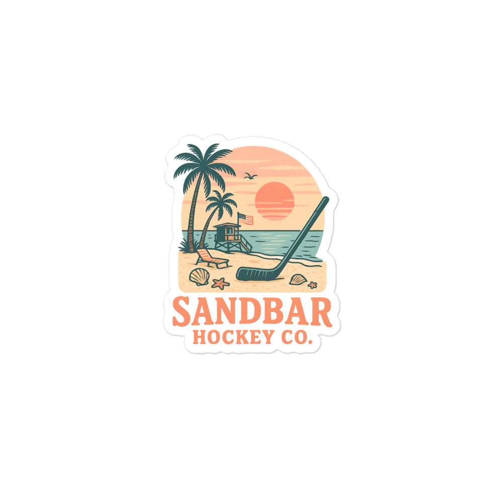 Medium Sandbar Hockey Co. sticker with palm trees, beach sunset, lifeguard stand, seashells, ocean water, and a hockey stick in the sand.