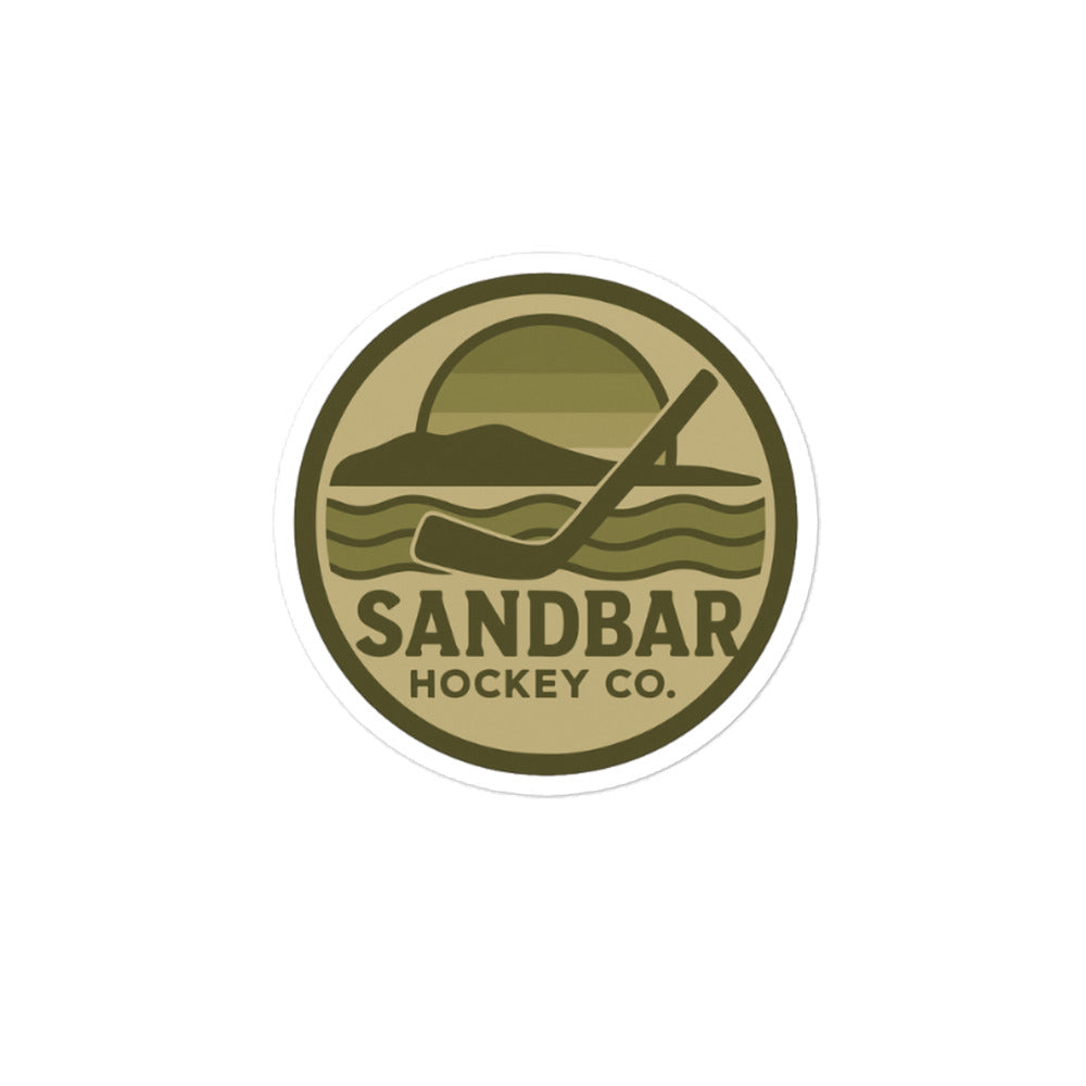 Medium Sandbar Hockey Co. camo circular logo sticker featuring a coastal hockey scene with a sunset, shoreline, waves, and hockey stick.