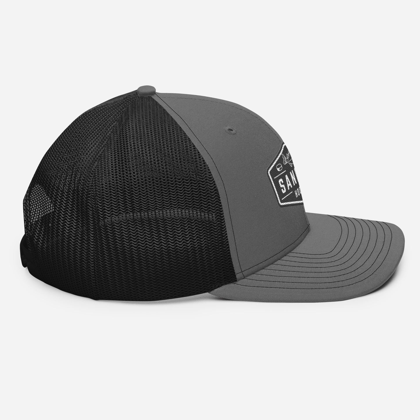 Dark grey and black Sandbar Hockey snapback hat left side profile view with curved brim and mesh back