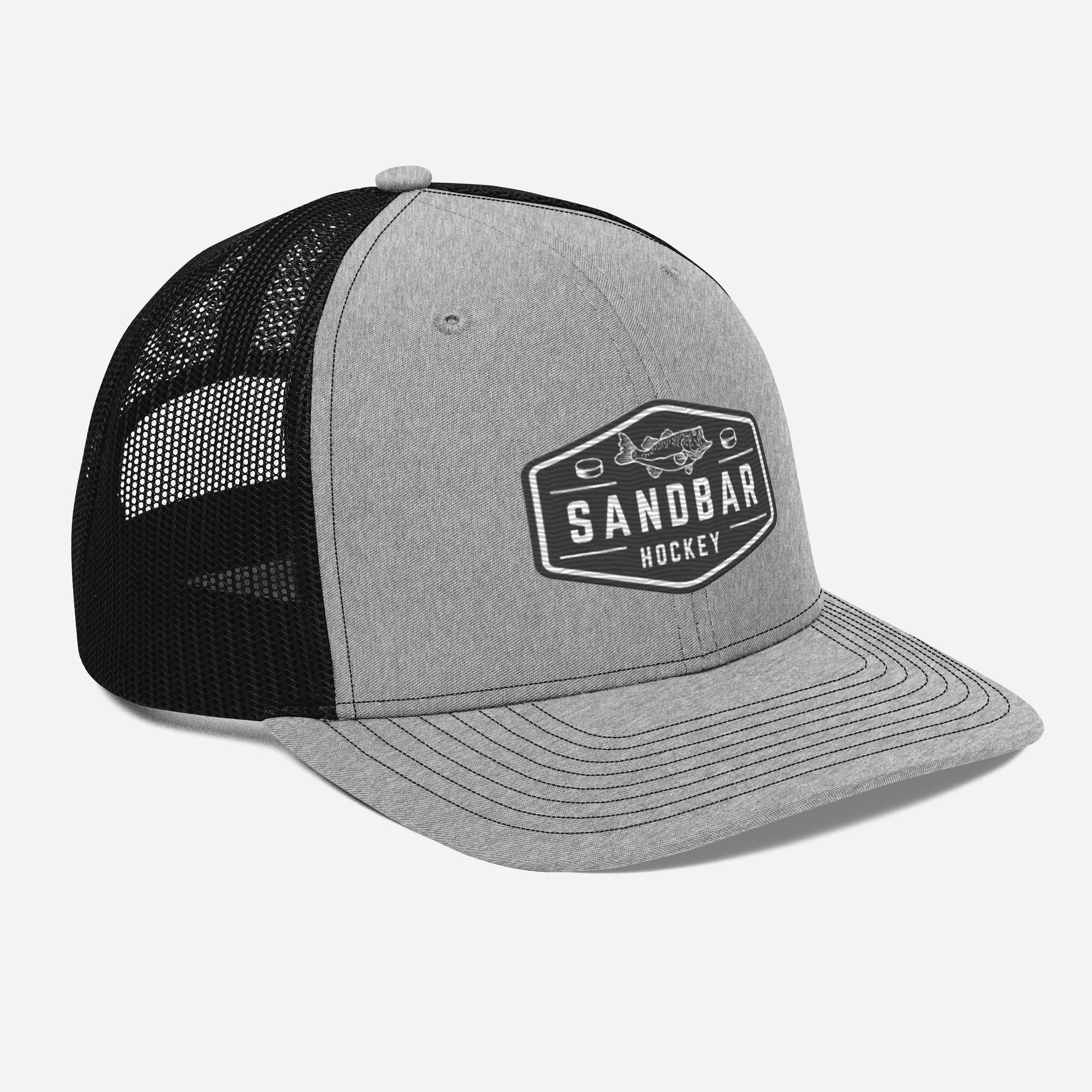Light grey and black Sandbar Hockey snapback hat angled front view with rectangular badge logo featuring a fish
