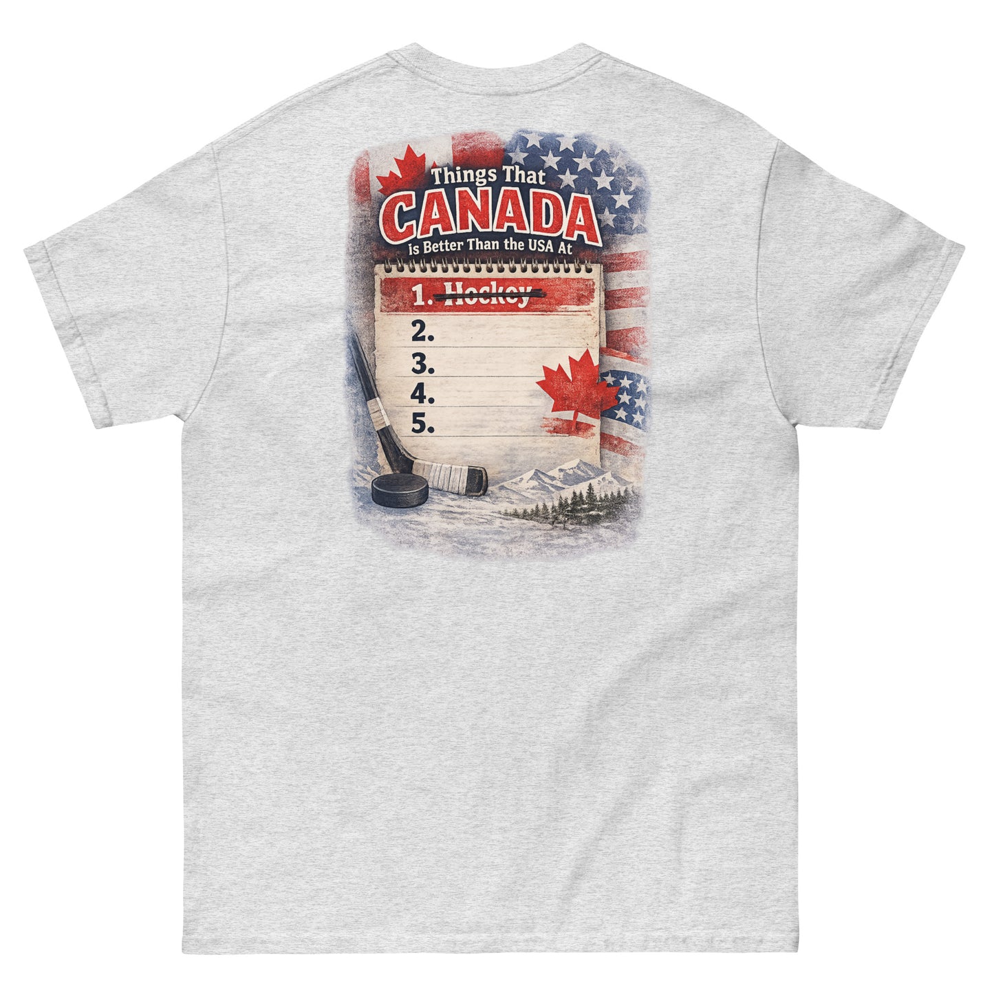 Ash hockey t-shirt with large back graphic that reads “Things That Canada Is Better Than the USA At” with “Hockey” crossed out at number one, plus American and Canadian flag elements, a hockey stick, puck, and mountain background.
