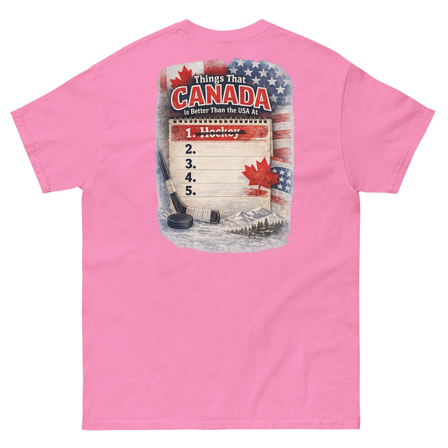 Pink hockey t-shirt with large back graphic that reads “Things That Canada Is Better Than the USA At” with “Hockey” crossed out at number one, plus American and Canadian flag elements, a hockey stick, puck, and mountain background.