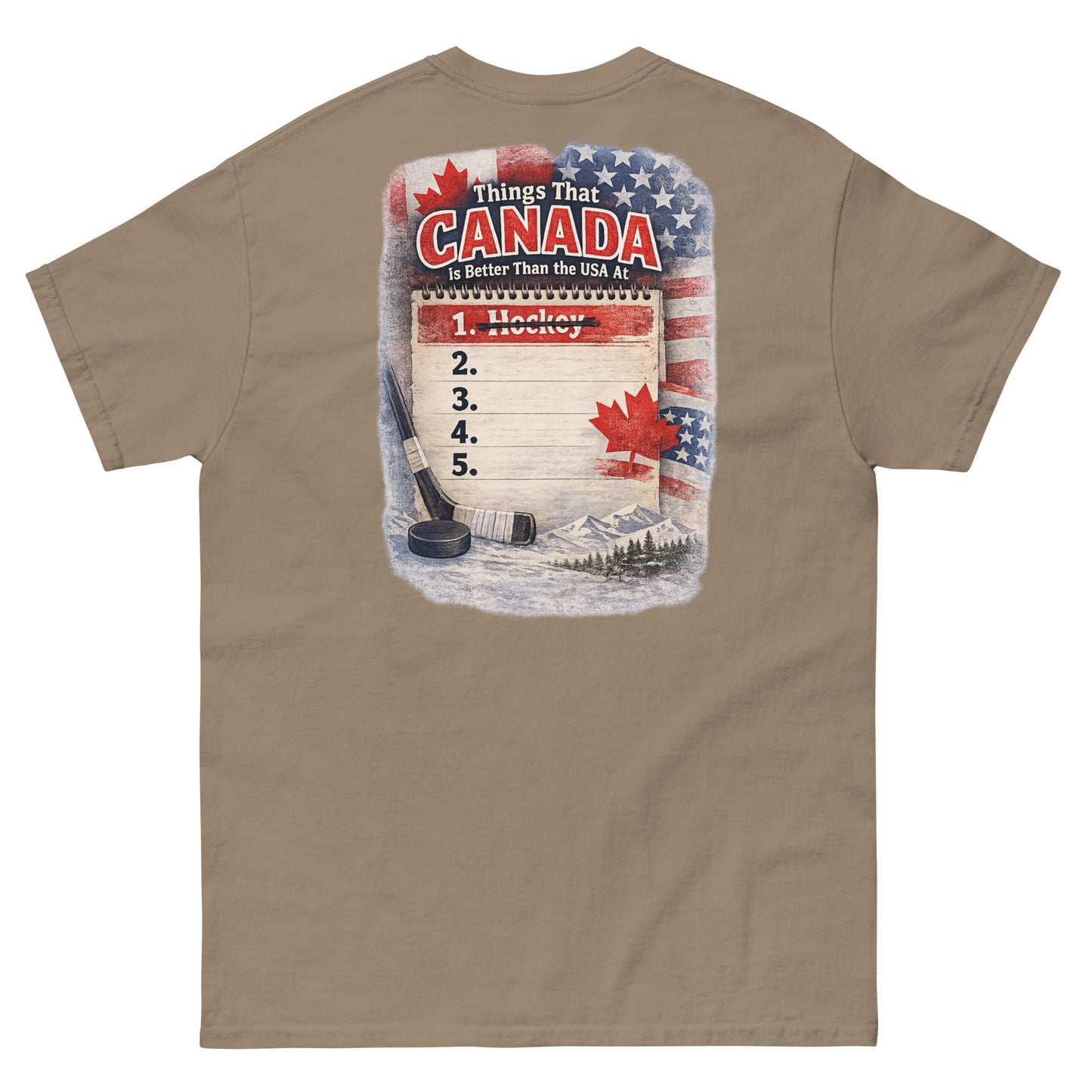 Brown  hockey t-shirt with large back graphic that reads “Things That Canada Is Better Than the USA At” with “Hockey” crossed out at number one, plus American and Canadian flag elements, a hockey stick, puck, and mountain background.