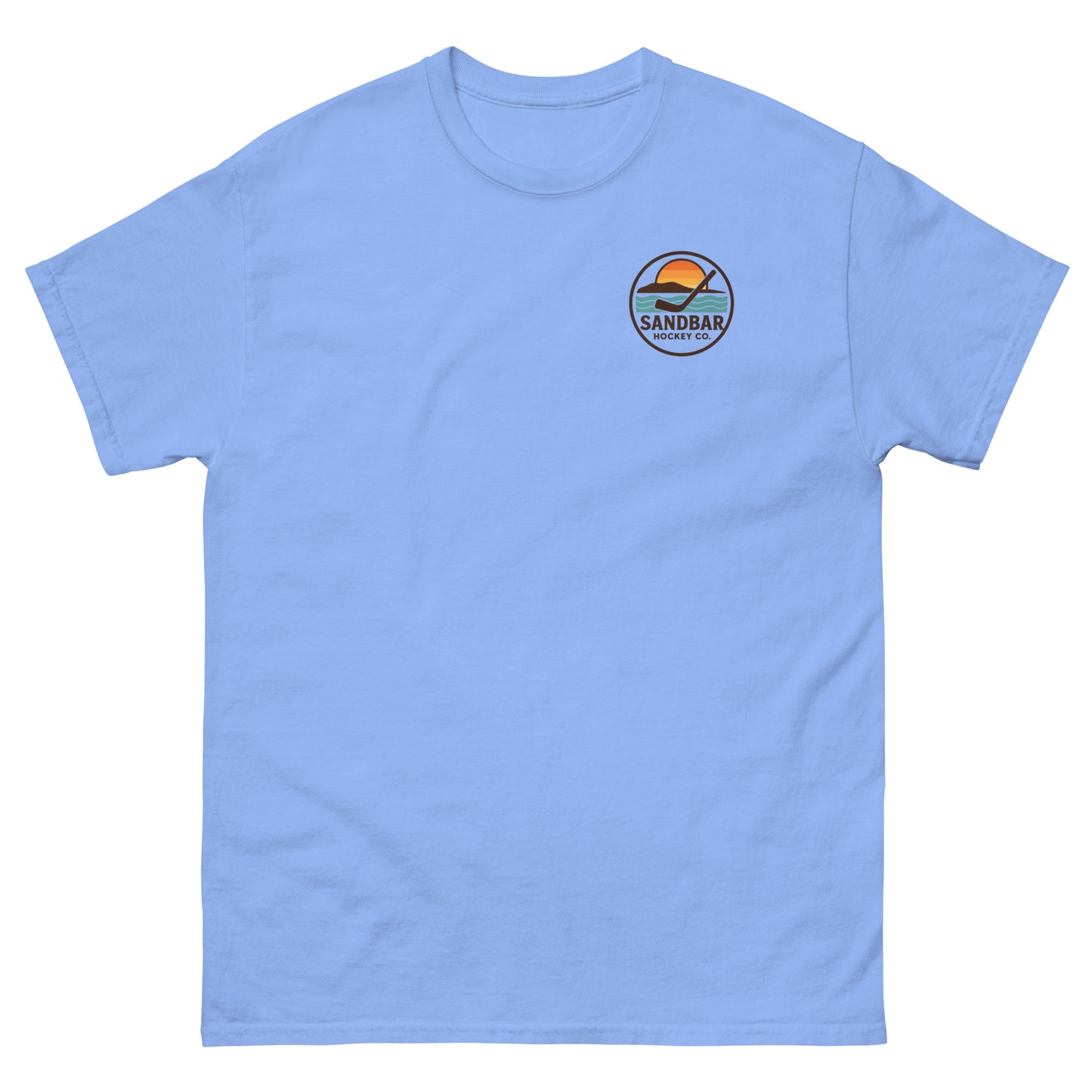 Carolina blue T-shirt with a small left chest logo showing a sunset, ocean waves, and a hockey stick with the text “Sandbar Hockey Co.”