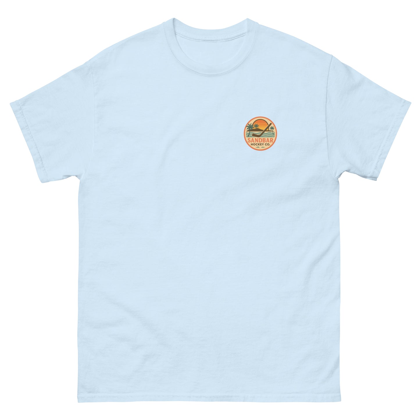 Pale blue hockey t-shirt front side with small circular Sandbar Hockey Co. sunset, palm tree, ocean wave, and hockey stick chest logo