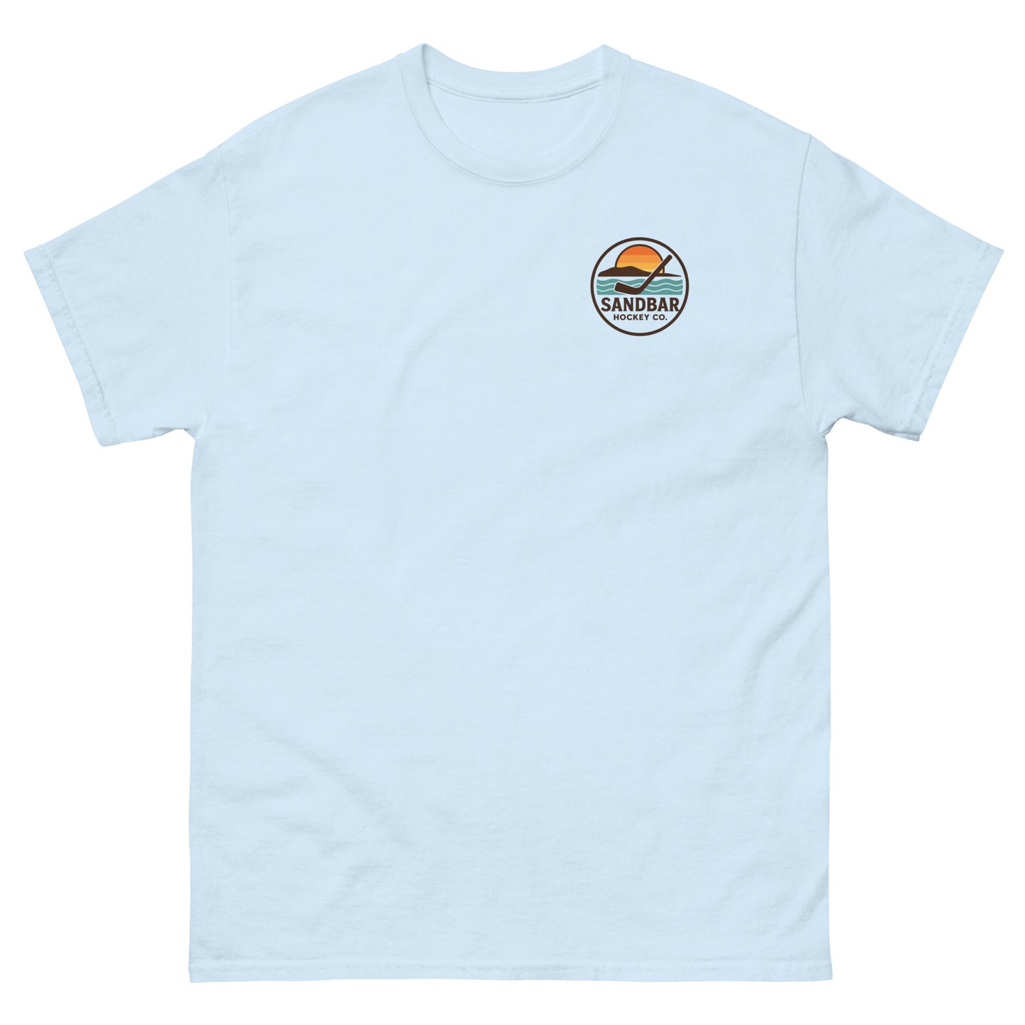 Light blue hockey t-shirt with small front chest logo featuring a circular Sandbar Hockey Co. sunset-and-stick emblem.