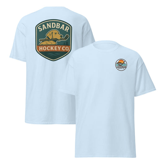 Light blue Sandbar Hockey Dog Badge T-Shirt front and back mockup with large shield-style back graphic of a dog holding a hockey stick in its mouth and small circular Sandbar Hockey Co. chest logo on front