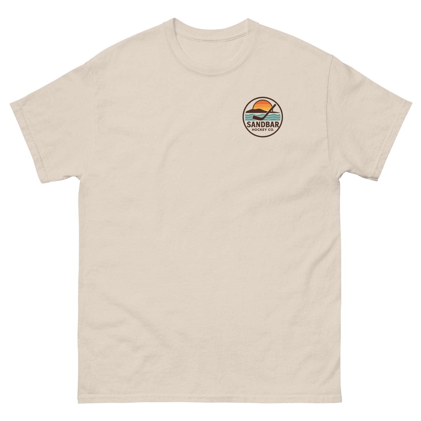 Natural T-shirt with a small left chest logo showing a sunset, ocean waves, and a hockey stick with the text “Sandbar Hockey Co.”