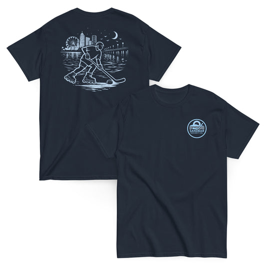 Navy blue roller hockey t-shirt showing back graphic with a roller hockey player skating by the water at night and blue front chest Sandbar Hockey Co. logo.