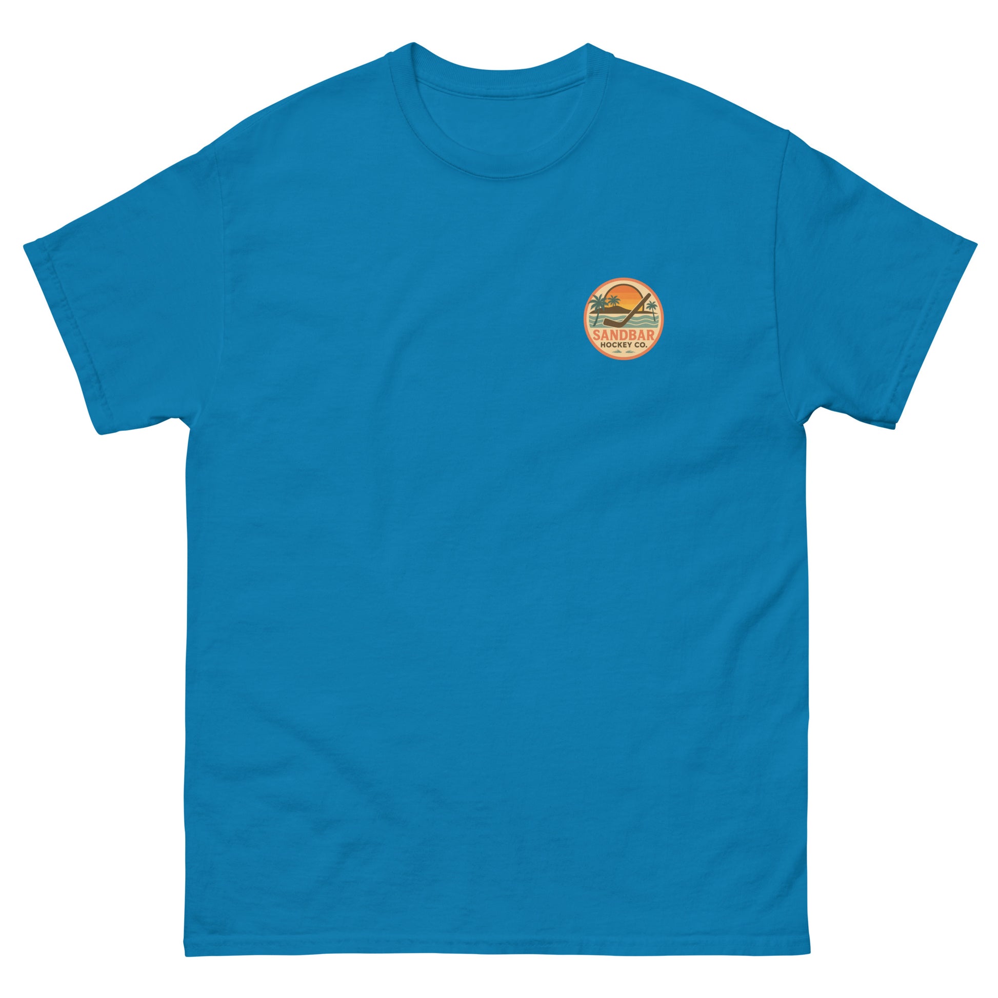 Blue hockey t-shirt front side with small circular Sandbar Hockey Co. sunset, palm tree, ocean wave, and hockey stick chest logo