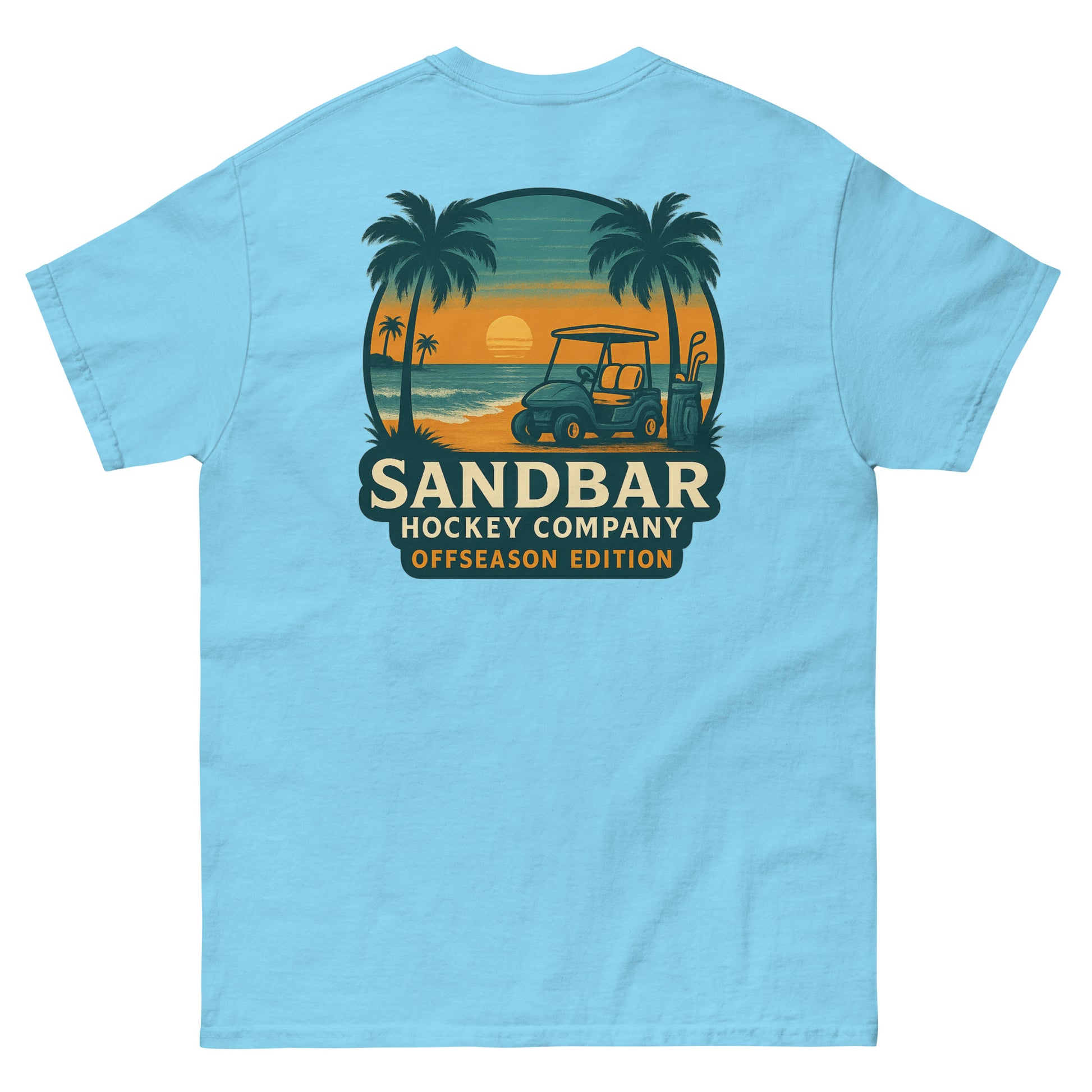 Sky blue T-shirt with a large back graphic of a beach sunset scene featuring palm trees, ocean waves, a golf cart, hockey sticks, and the text “Sandbar Hockey Company Offseason Edition.”