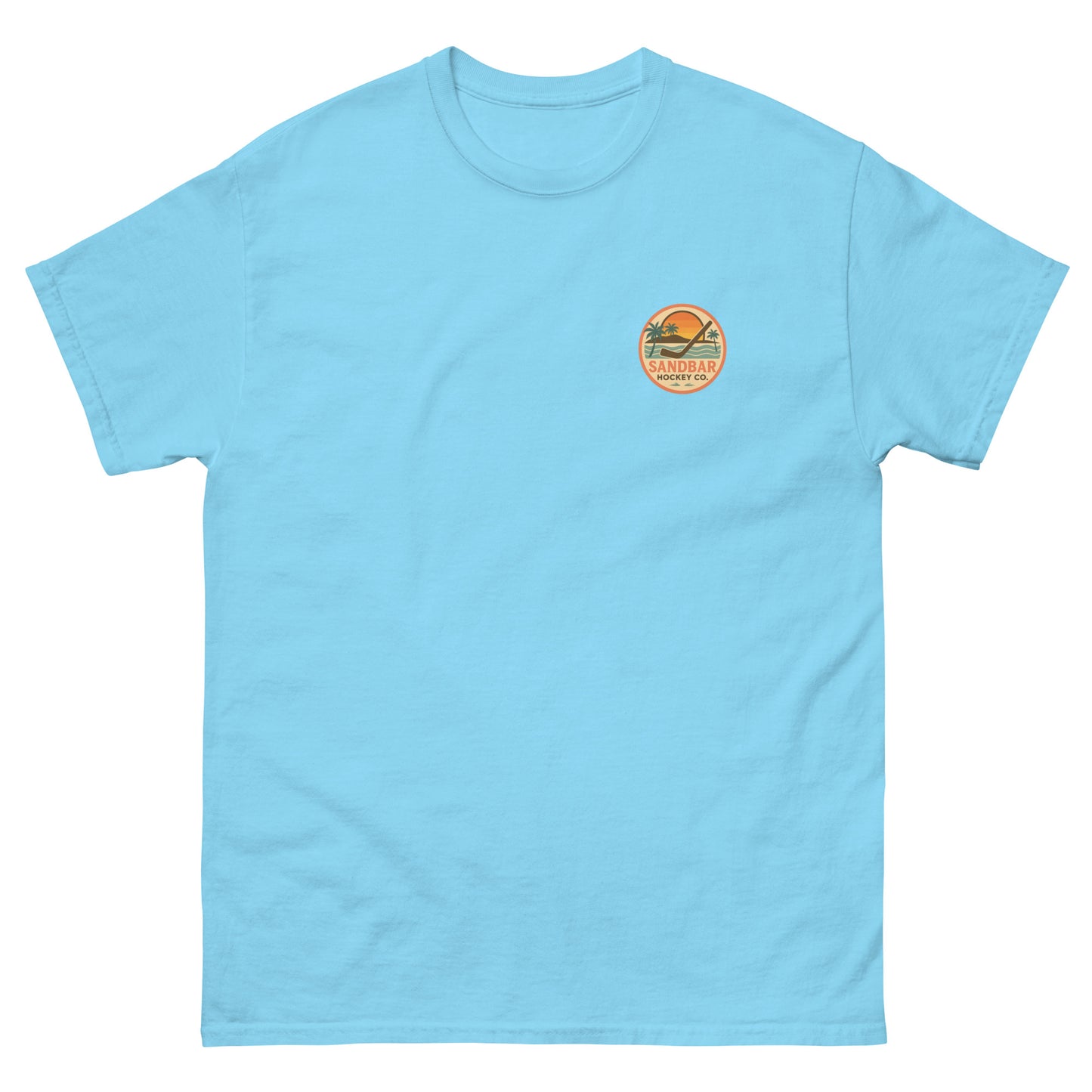 Light blue hockey t-shirt front side with small circular Sandbar Hockey Co. sunset, palm tree, ocean wave, and hockey stick chest logo