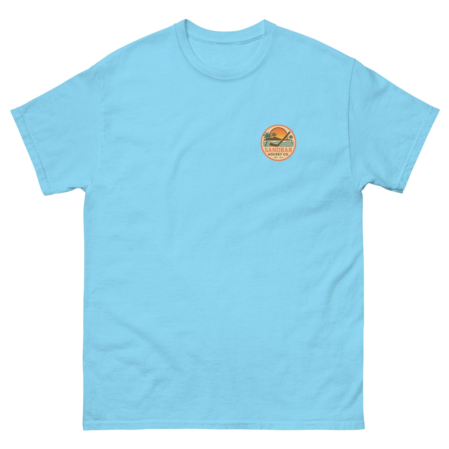 Light blue hockey t-shirt front side with small circular Sandbar Hockey Co. sunset, palm tree, ocean wave, and hockey stick chest logo