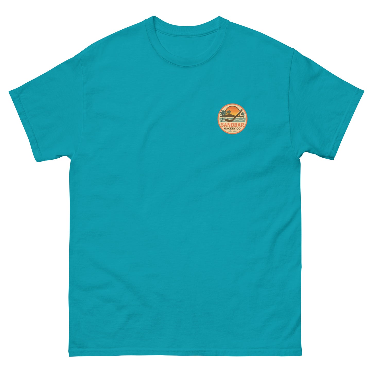 Teal hockey t-shirt front side with small circular Sandbar Hockey Co. sunset, palm tree, ocean wave, and hockey stick chest logo