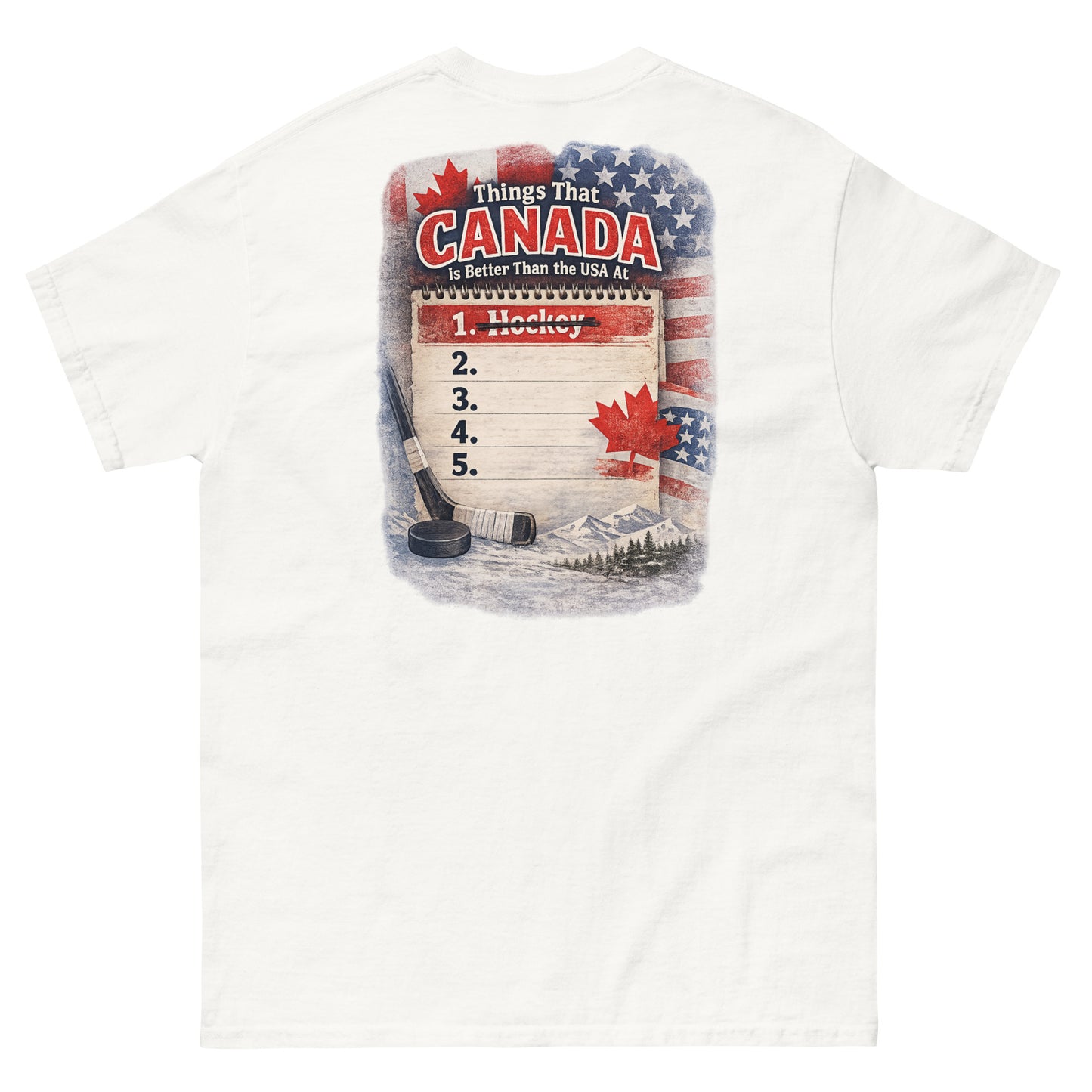 White hockey t-shirt with large back graphic that reads “Things That Canada Is Better Than the USA At” with “Hockey” crossed out at number one, plus American and Canadian flag elements, a hockey stick, puck, and mountain background.