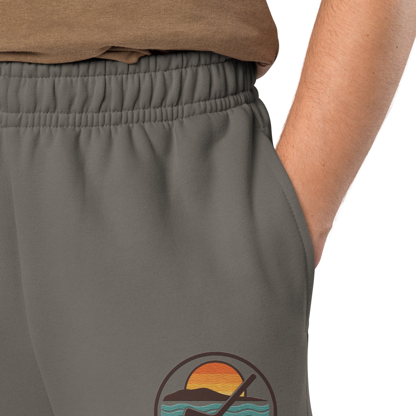 Asphalt hockey sweatpants close-up of left leg with Sandbar Hockey Co. sunset wave logo