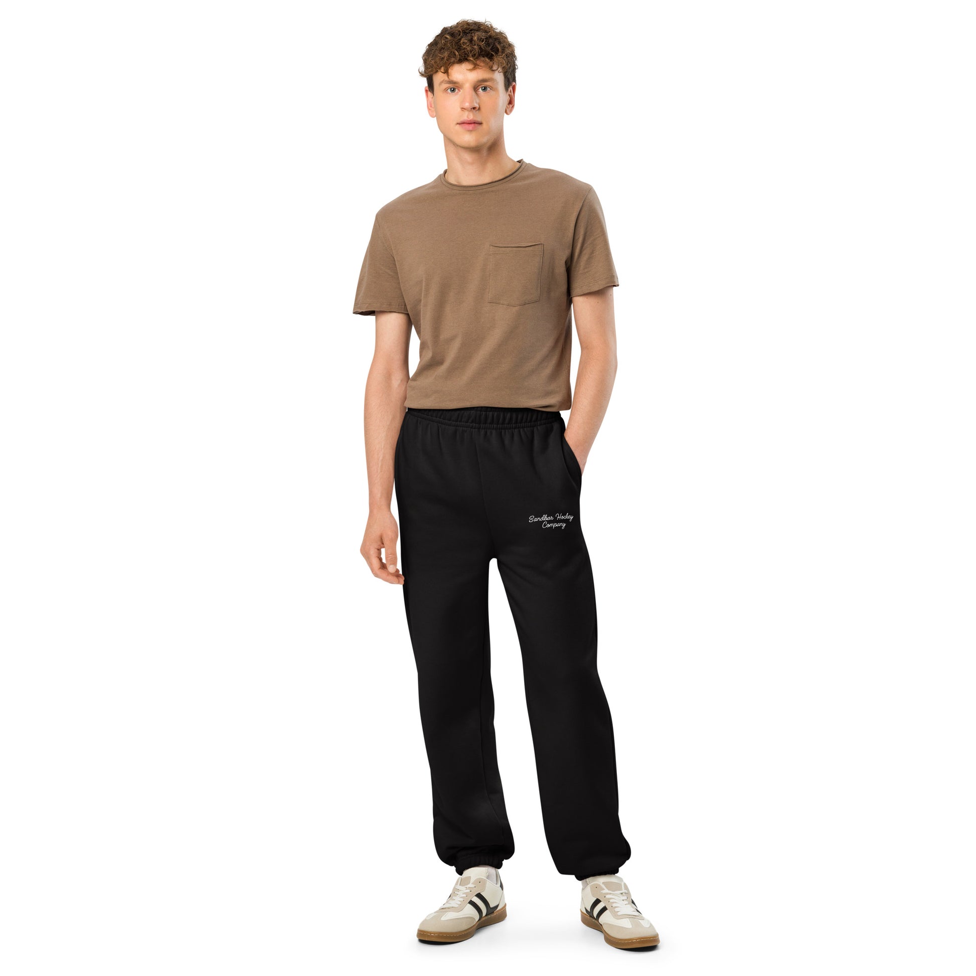 Black hockey sweatpants full front view on model with side pockets