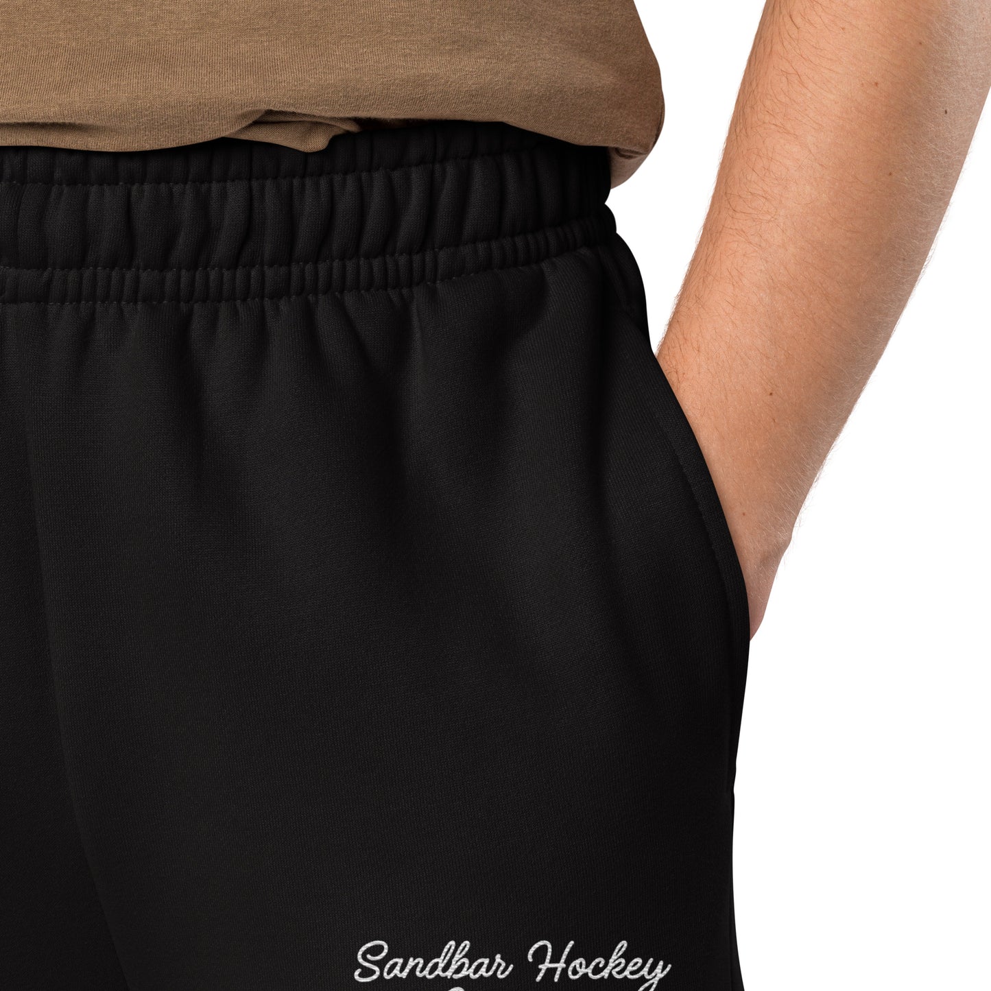 Black hockey sweatpants close-up of left leg with Sandbar Hockey Company cursive logo