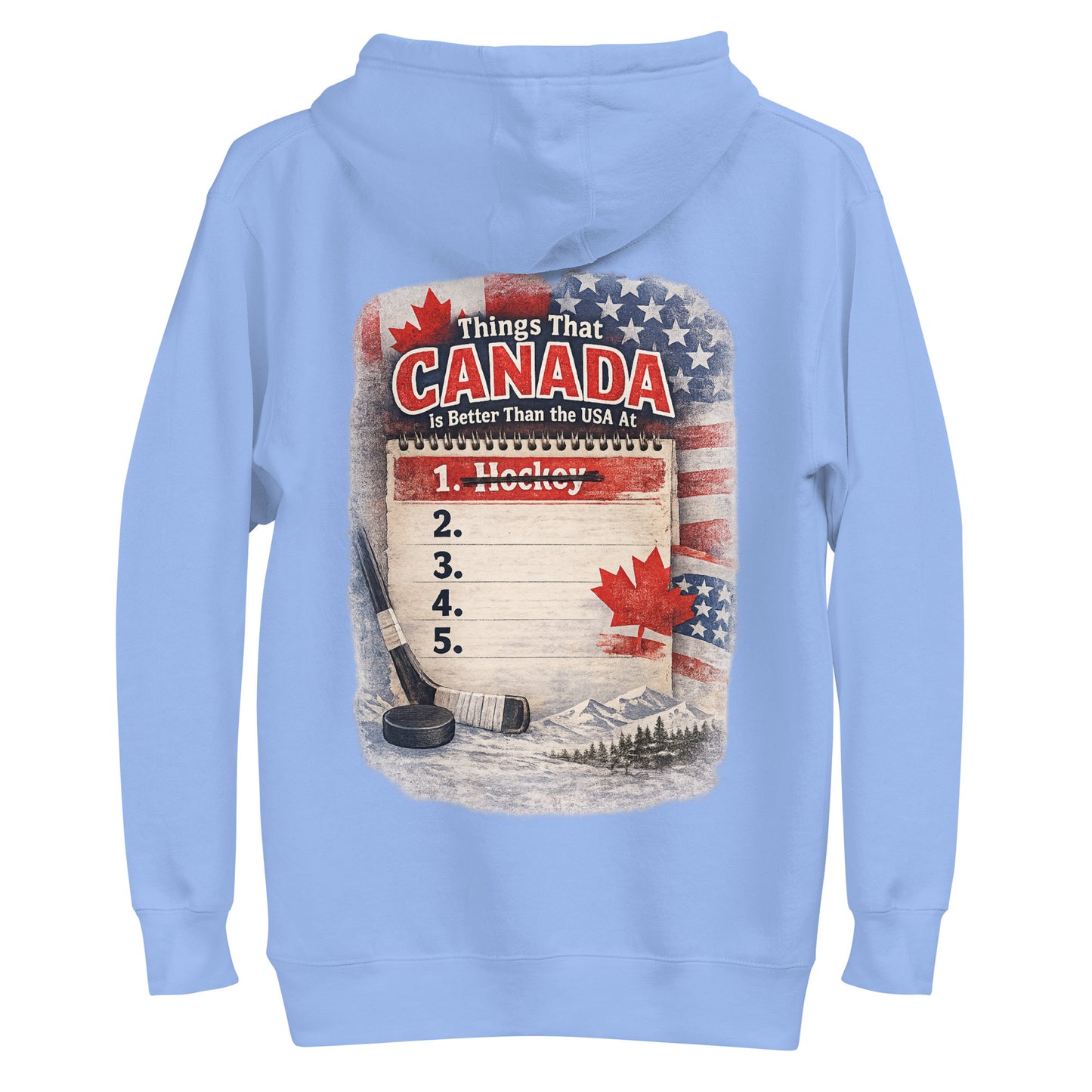 Carolina blue hockey hoodie with the large back graphic that says “Things That Canada Is Better Than the USA At,” featuring the notepad list, crossed-out “1. Hockey,” flags, maple leaf, stick, puck, and mountain background.