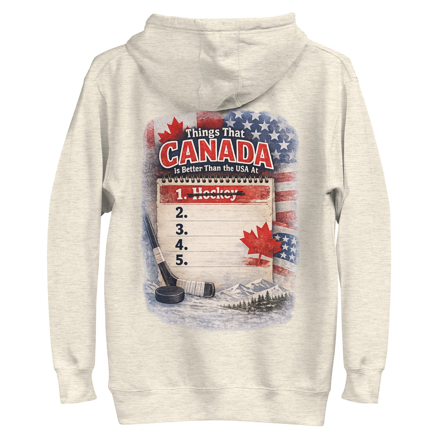 Cream hockey hoodie with the large back graphic that says “Things That Canada Is Better Than the USA At,” with the crossed-out “1. Hockey” list, flags, maple leaf, stick, puck, and mountain background.