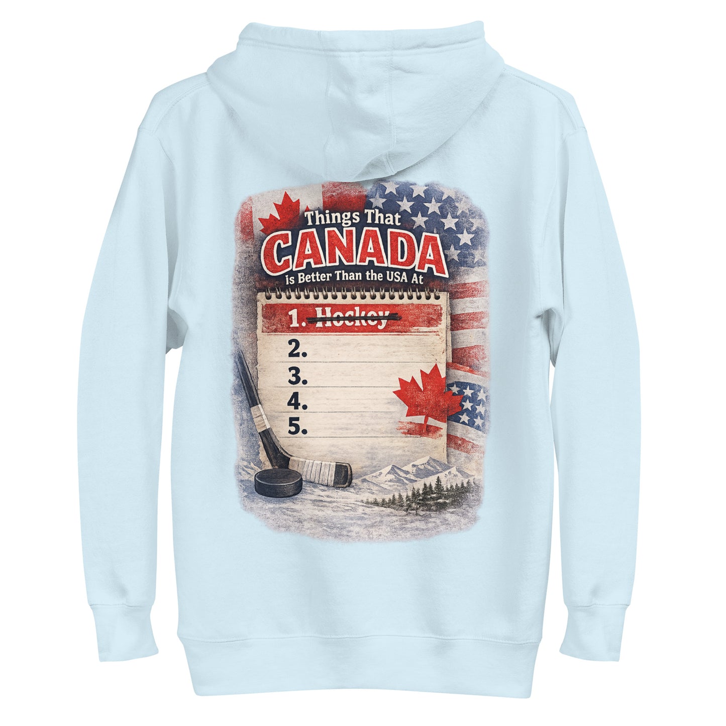 Light blue hockey hoodie with a large back graphic that says “Things That Canada Is Better Than the USA At,” featuring a notepad list with “1. Hockey” crossed out, plus Canadian and American flags, a hockey stick, puck, maple leaf, and mountain background.
