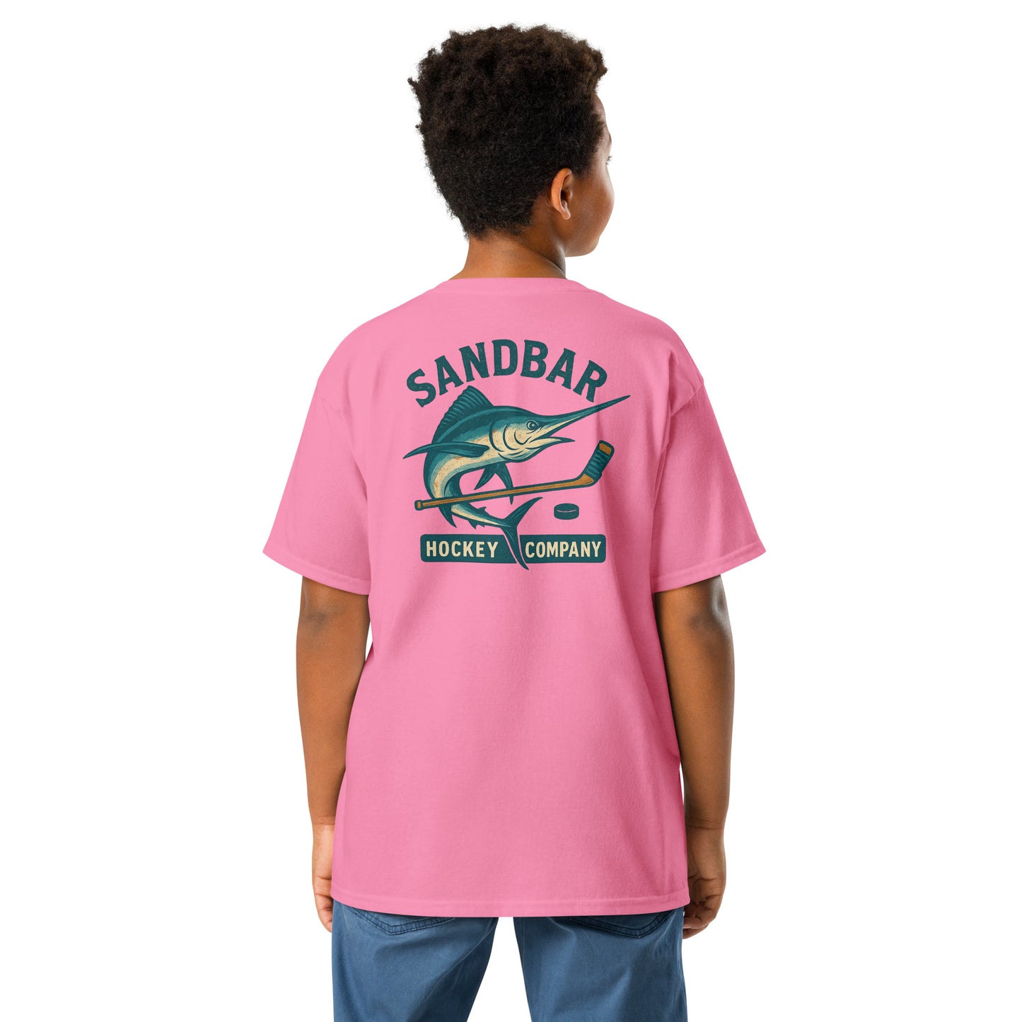 Pink youth hockey t-shirt back side on model with marlin and hockey stick graphic and Sandbar Hockey Company text