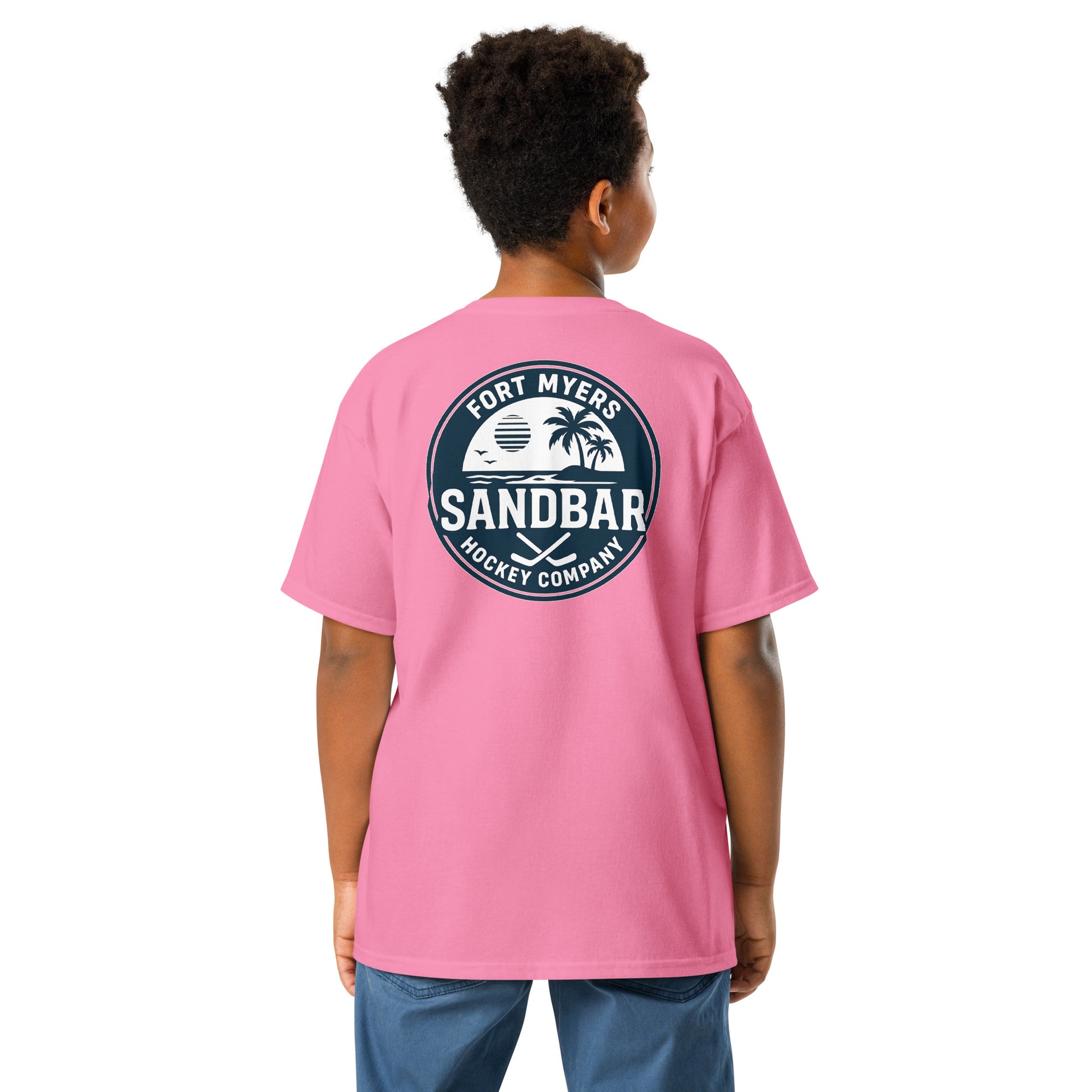 Pink Youth Fort Myers Sandbar Hockey T-shirt back view with large circular Fort Myers Sandbar Hockey Company graphic featuring palm trees, island, water, sunset, birds, and crossed hockey sticks