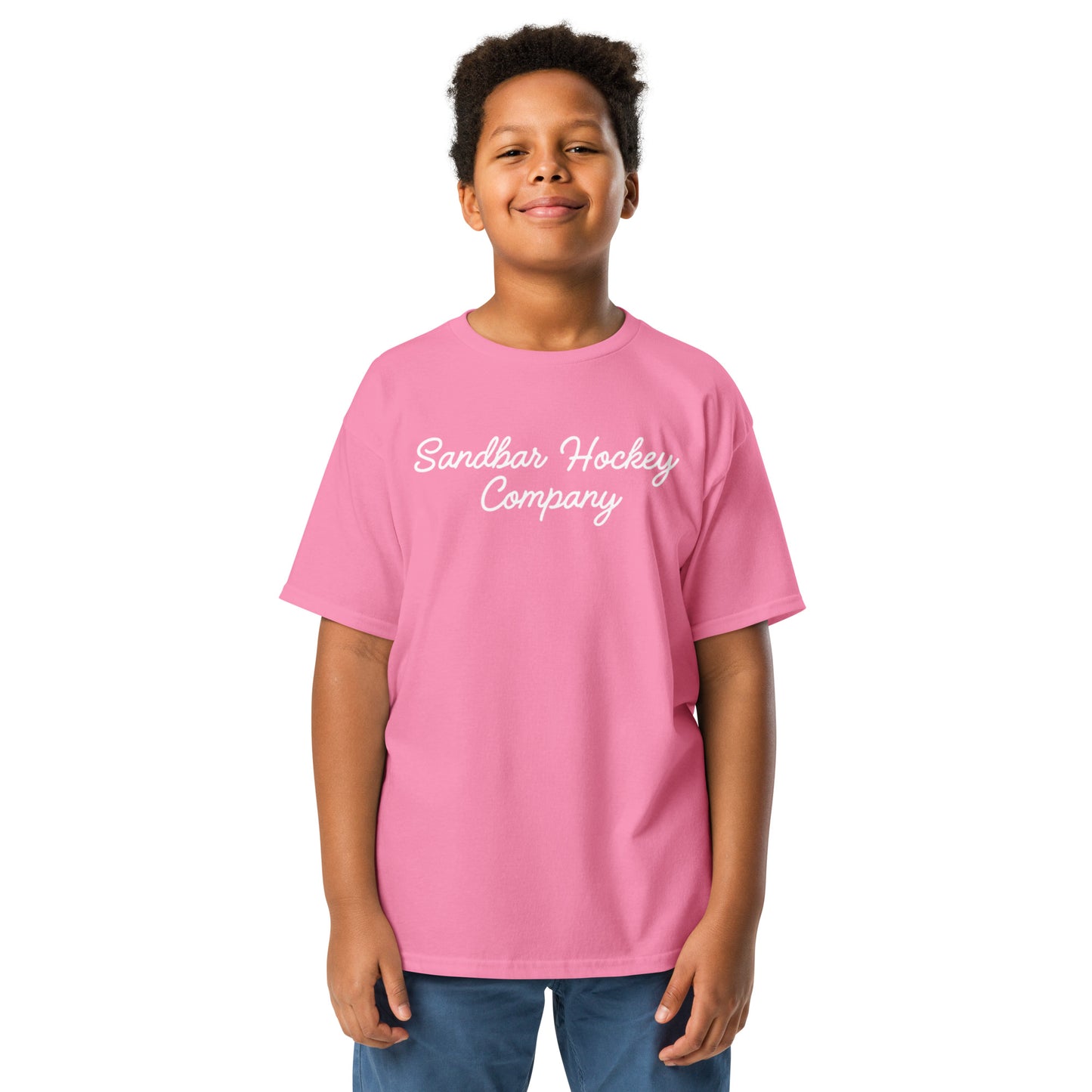 Pink youth T-shirt with “Sandbar Hockey Company” printed in white script across the front chest.