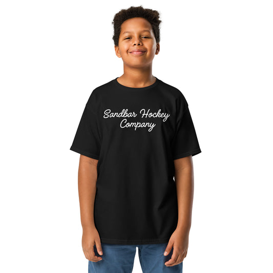 Black youth T-shirt with “Sandbar Hockey Company” printed in white script across the front chest.
