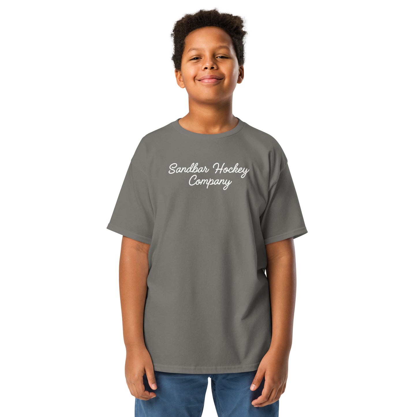 Charcoal youth hockey t-shirt shown from the front on a child model, featuring a white Sandbar Hockey Company script logo across the front chest.