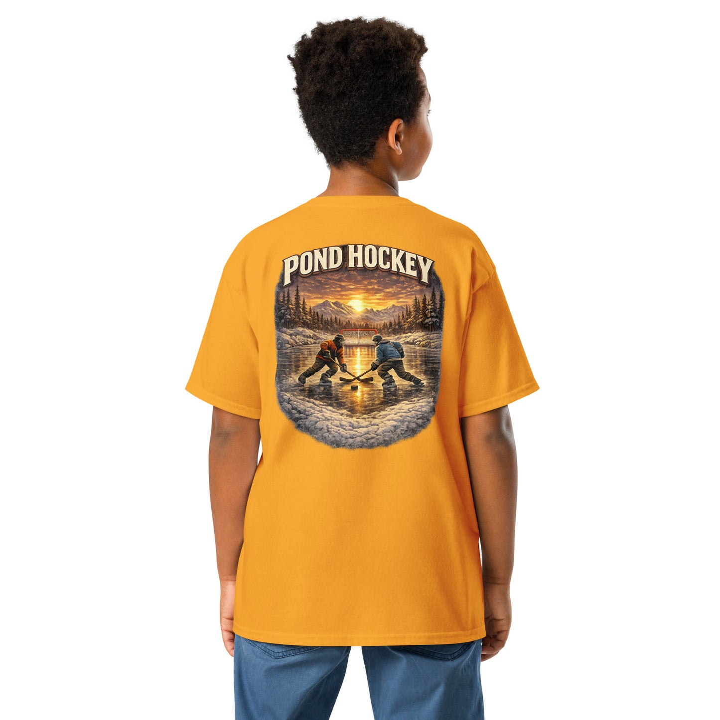 Gold youth T-shirt with a large back graphic showing two hockey players on a frozen pond at sunset, with mountains, pine trees, a goal net, and “POND HOCKEY” in bold lettering above.