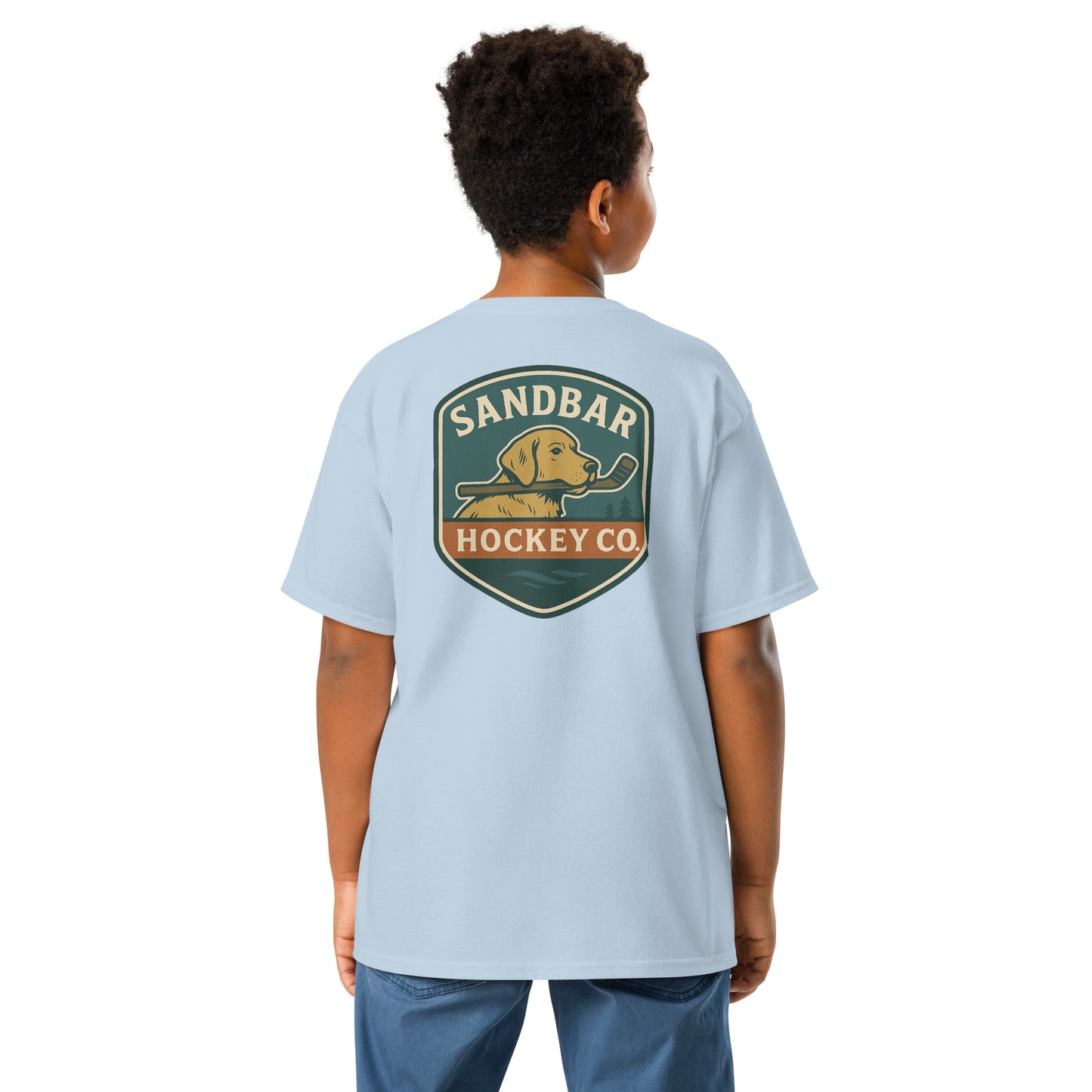 Youth light blue Sandbar Hockey Dog Badge T-Shirt back view on model with large badge graphic of a dog holding a hockey stick in its mouth