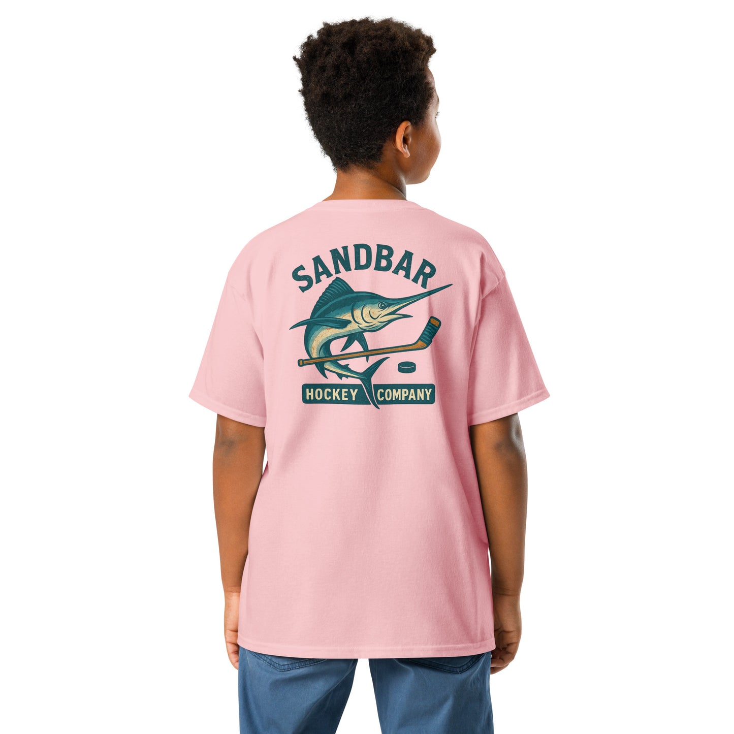 Light pink youth hockey t-shirt back side on model with marlin and hockey stick graphic and Sandbar Hockey Company text