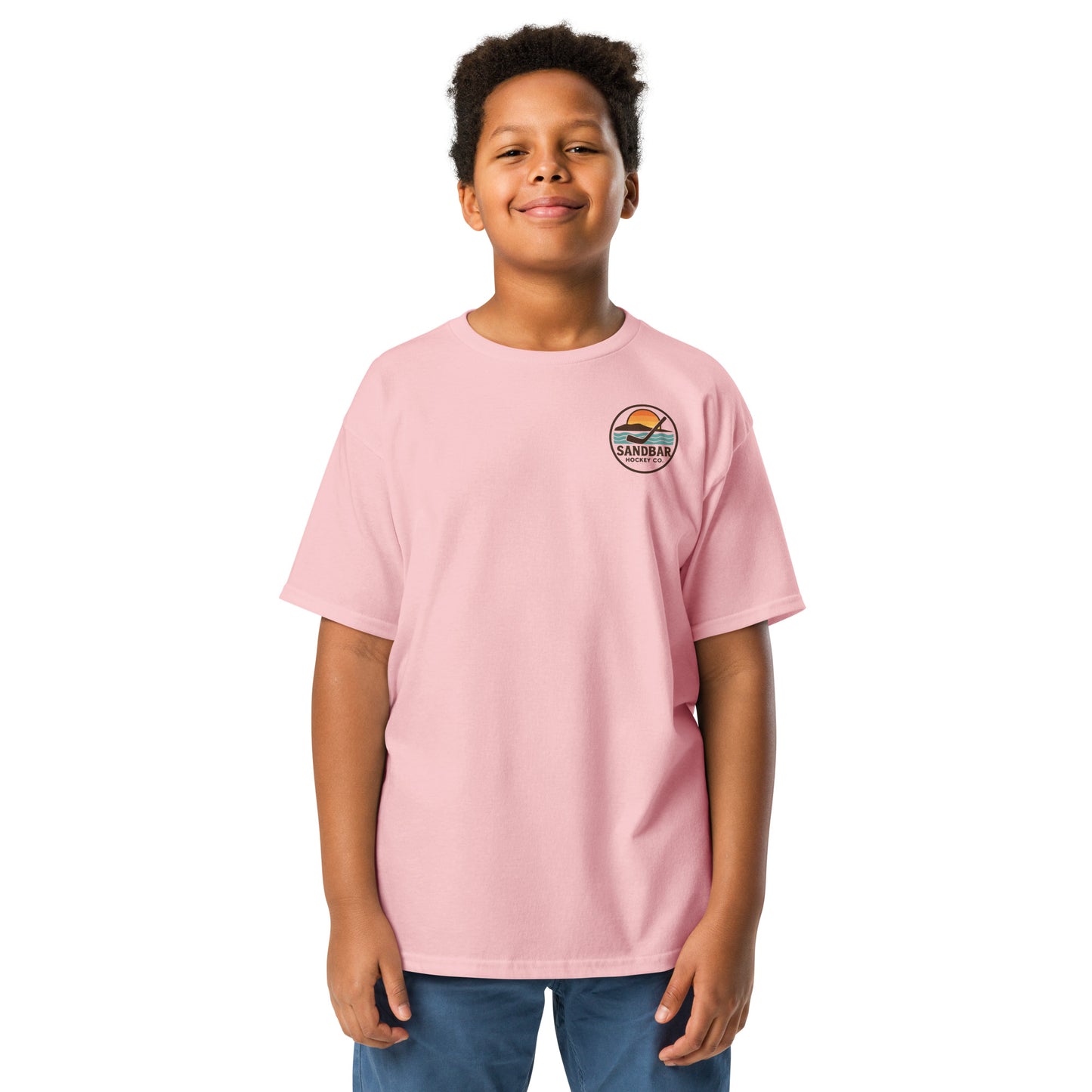 Youth pink Sandbar Hockey Dog Badge T-Shirt front view on model with small circular Sandbar Hockey Co. chest logo