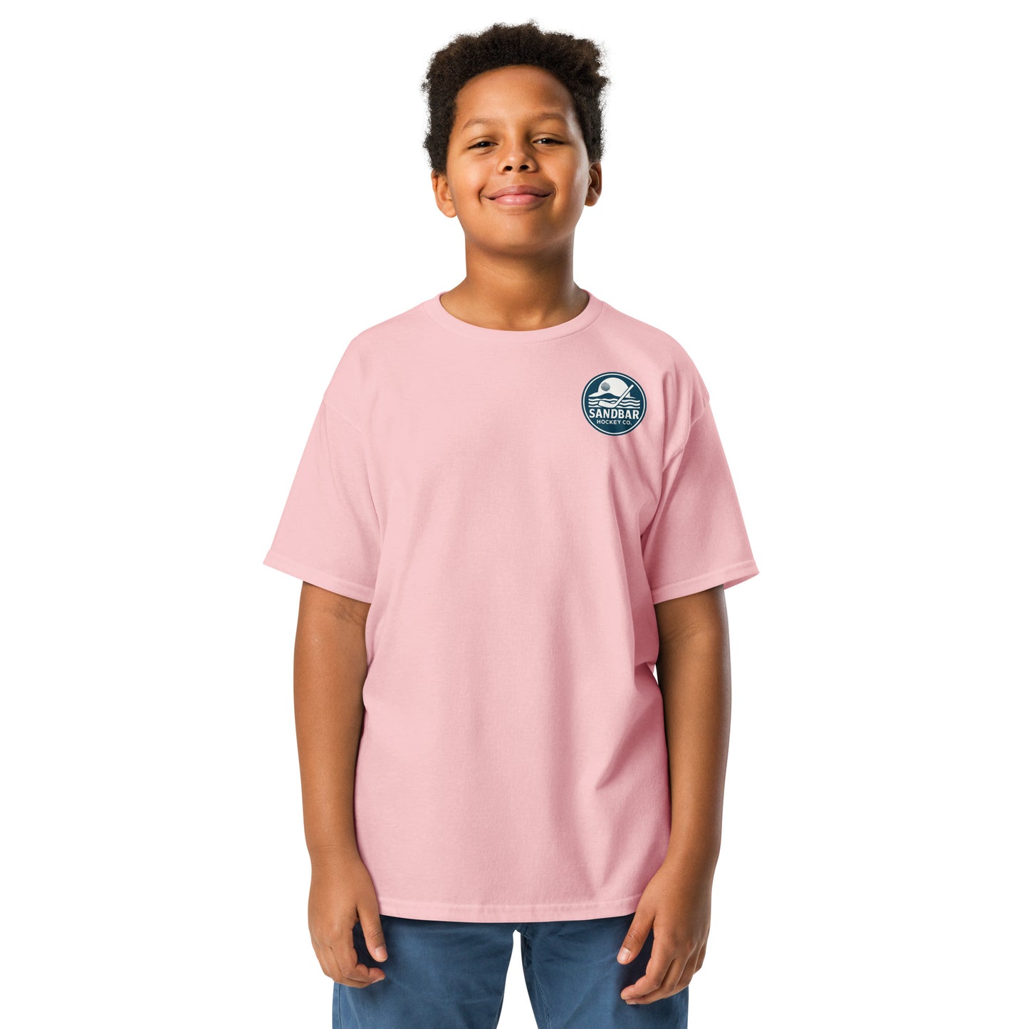 Light pink Orlando Sandbar Hockey youth t-shirt front view with small circular Sandbar Hockey Co. sunset and hockey stick logo on left chest