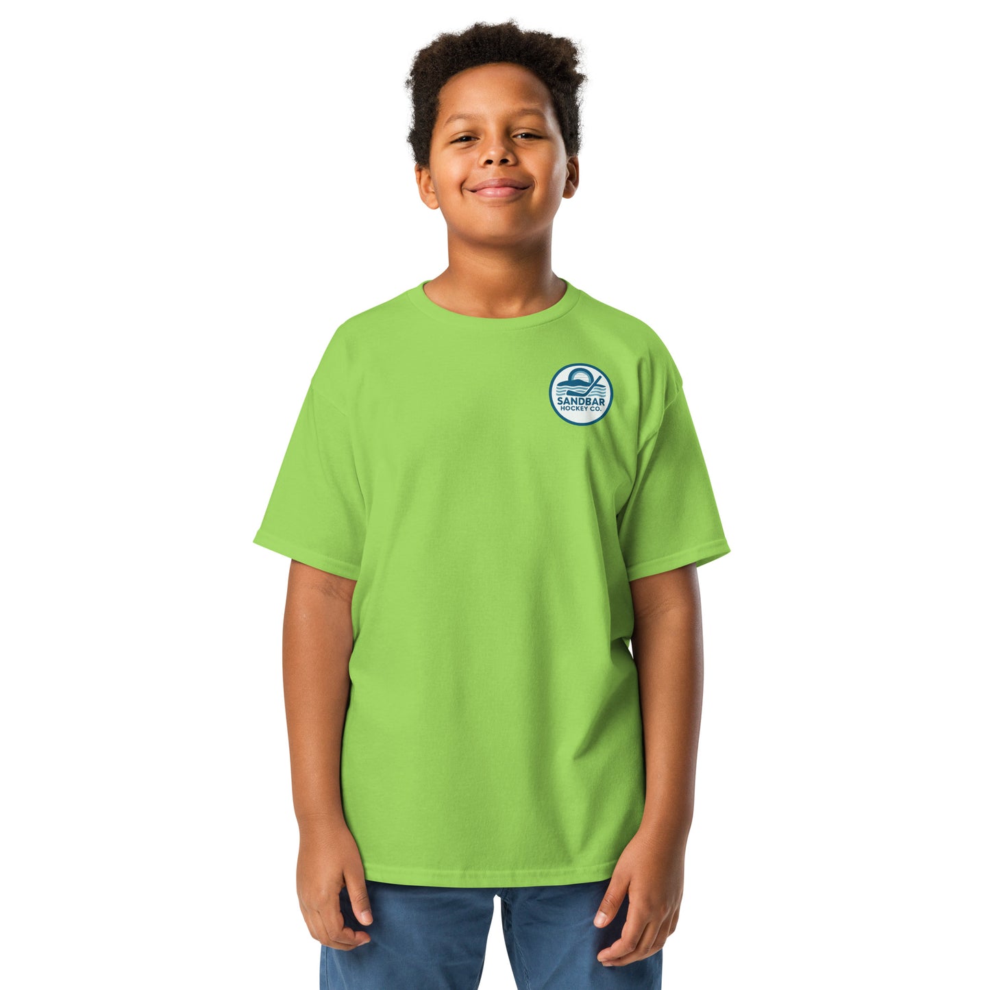 Lime green youth hockey t-shirt front side on model with small circular Sandbar Hockey Co. sunset, water, and hockey stick chest logo