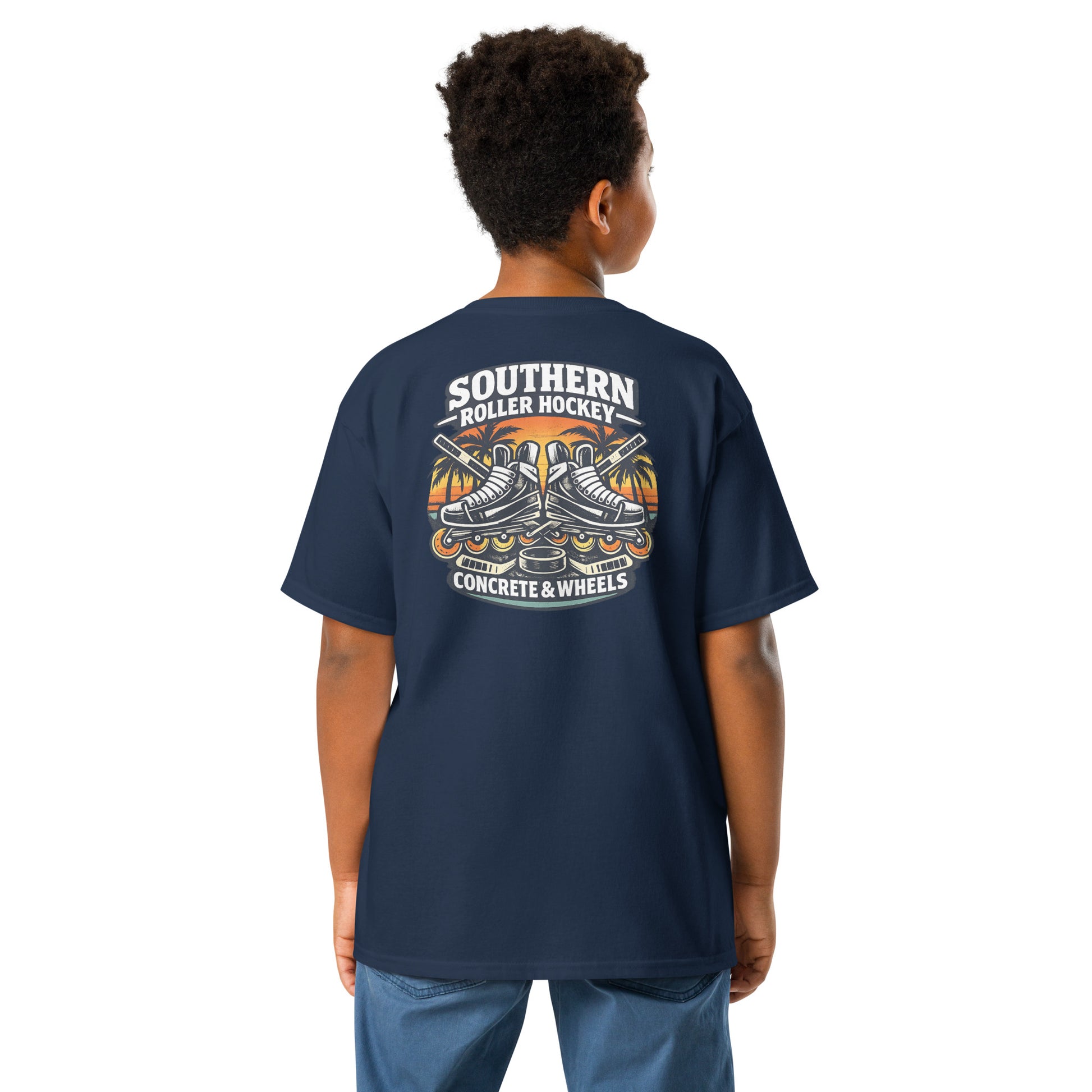 Youth navy southern roller hockey t-shirt back view worn by a boy, featuring the Southern Roller Hockey Concrete & Wheels graphic with inline skates, palm trees, sticks, and puck.